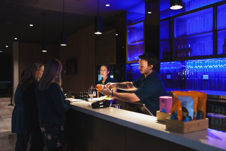 Ladies being served wine at a bar