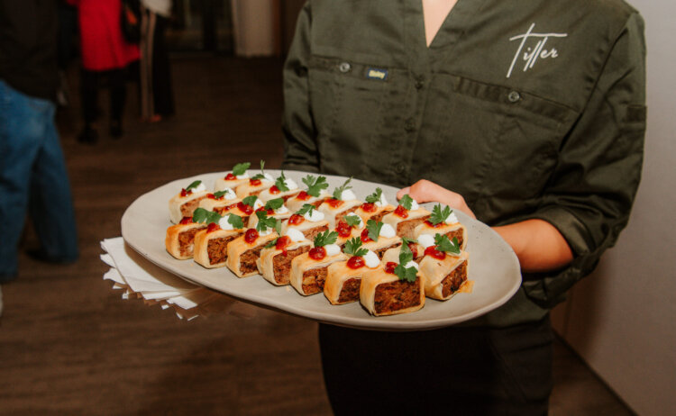 A waitress with a platter of canapes